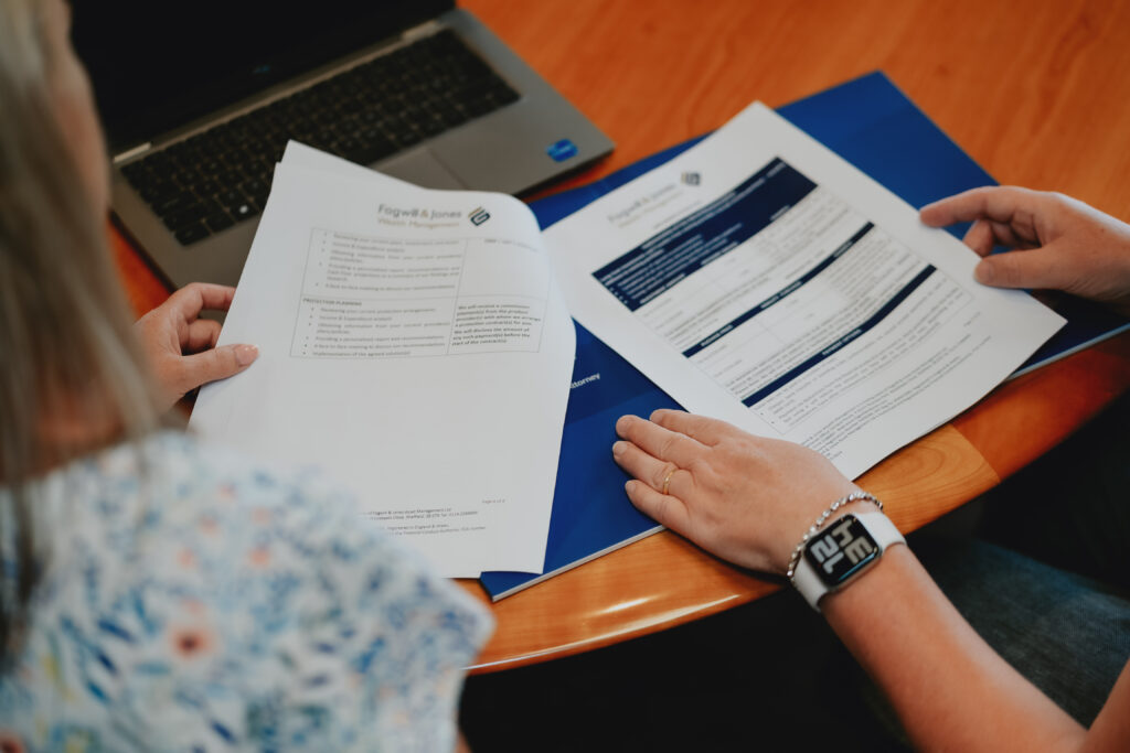 fogwill and jones documents on table as client and adviser look at them.