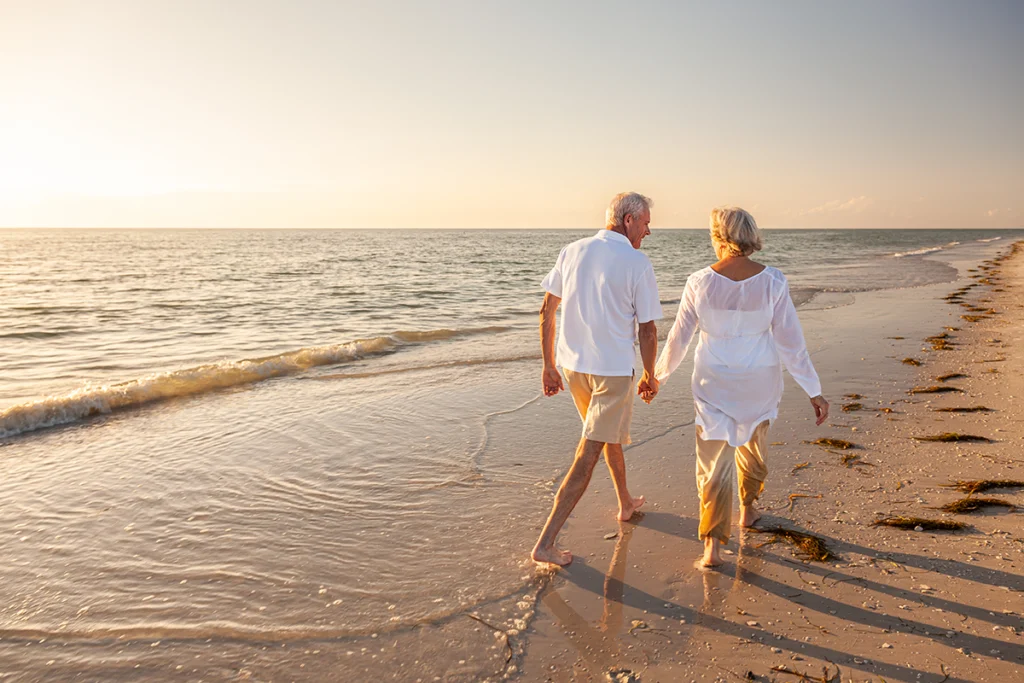 Retired Couple Walking on Beach