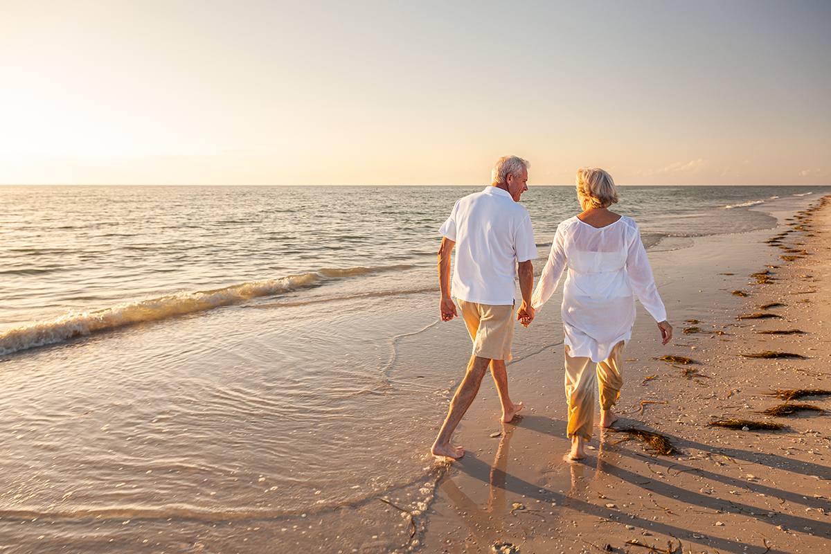 Retired Couple Walking on Beach